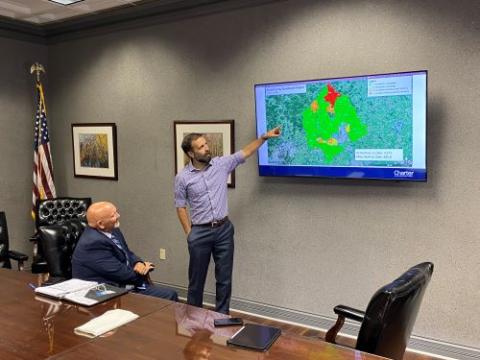 Joe Covington (Scott County Judge) and Benjamin U'sellis (Spectrum Leadership) review project deployment map